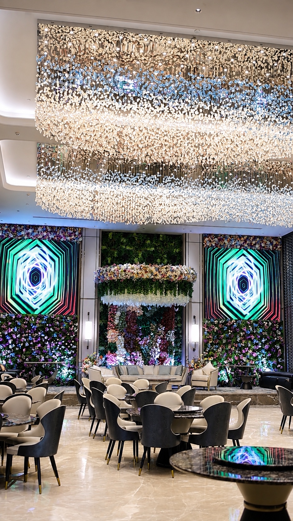 Wide view of Aroha Hall with its illuminated ceiling and stage